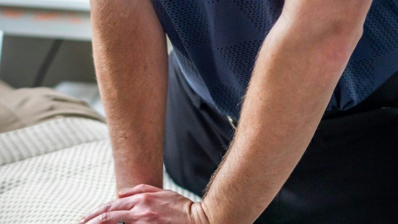 Chiropractic adjustment technique on a patient upper back